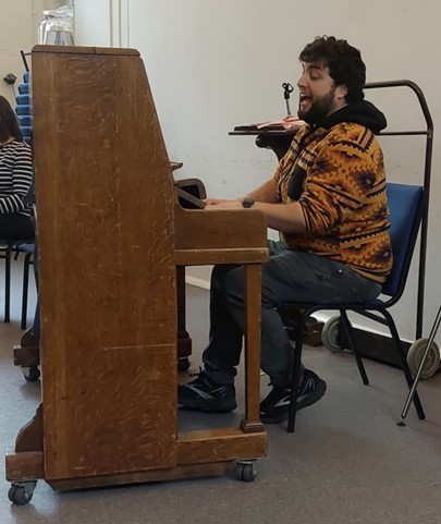 Figure seated at piano