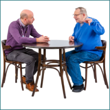 men chatting at a desk