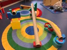 Multi coloured floor rugs with climbing blocks and tubes