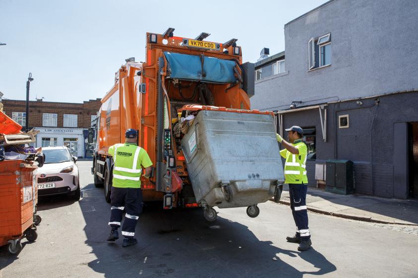 A refuse crew collecting trade waste